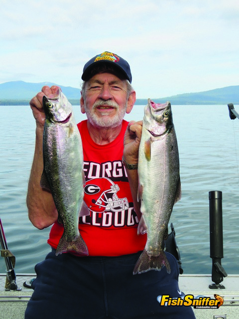 Gene Rush holds up the pair of handsome rainbow trout he caught while slow trolling worms at Lake Almanor on July 8.