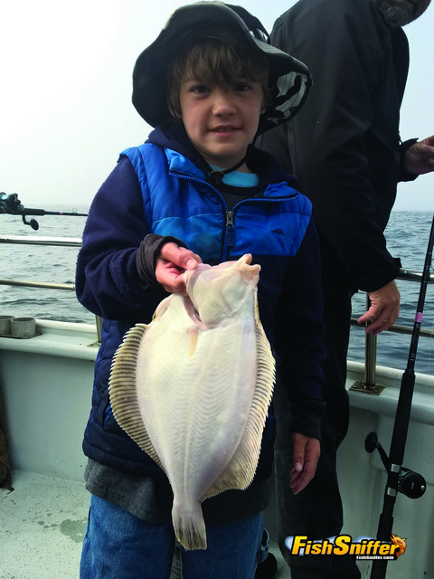 Jacob Ward shows off a handsome rocksole he caught while fishing about the Sea Wolf during the recent Cub Scout saltwater adventure.