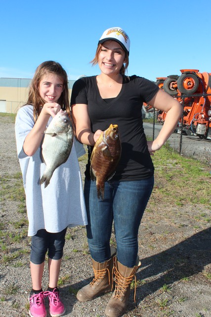 Kira Eccleston (right) won first place in the women’s sea perch division with a 1.9 lb. 12-3/4 inch rainbow perch taken while fishing off Monterey with a bloodworm. 
