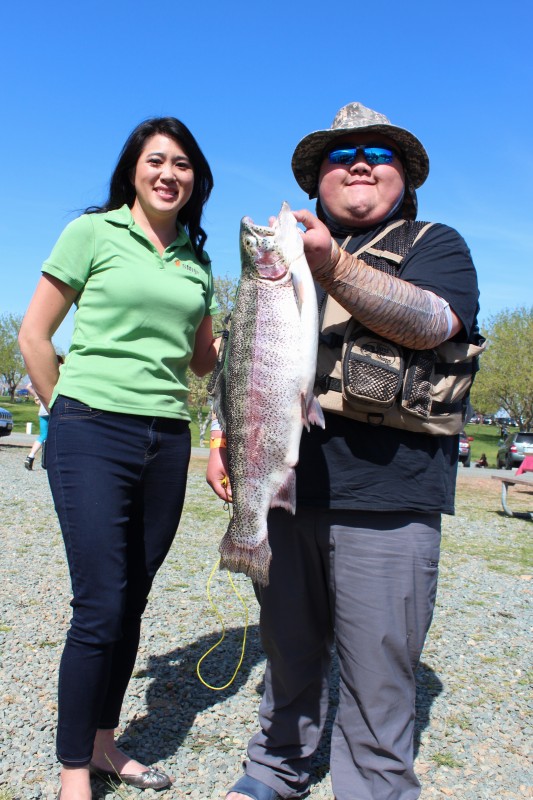 SMUD Director Nancy Bui-Thompson and Jerry Xiong  pose with his  7.84 lb. rainbow that earned him first place in the adult division of the first day of the SMUD Trout Derby on April 1. 