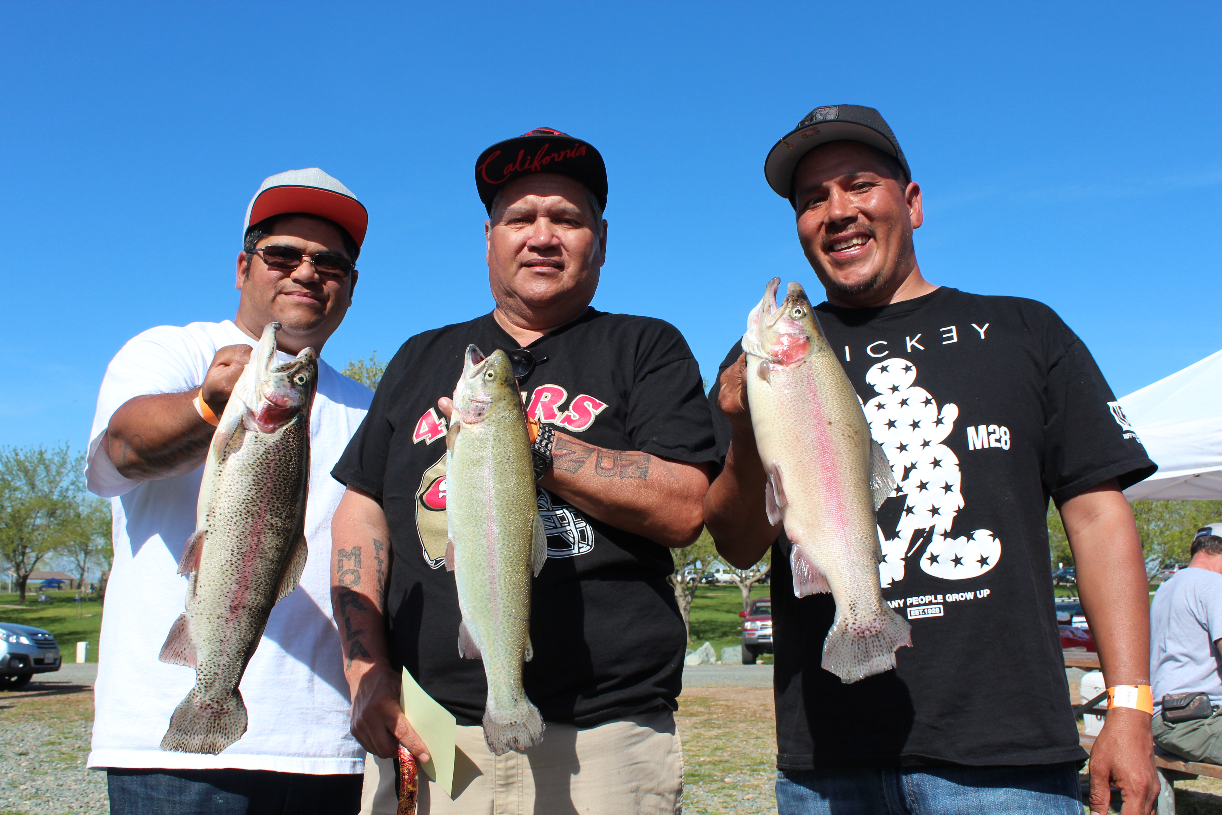 Clarence Morla, John Morla, and John Morla Jr. hold up three hefty rainbows that they caught from their Jacson Rancheria boat on day one of the SMUD Rancho Seco Trout Derby.