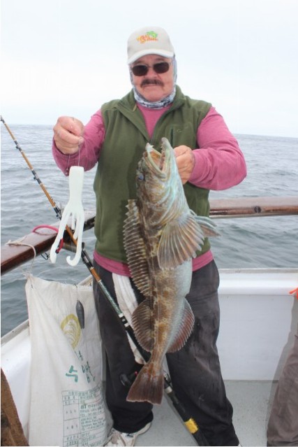 George White of Antioch holds up a just-caught lingcod aboard the California Dawn.
